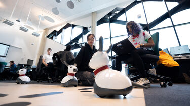Two computer science students in the computer labs with Miro robots