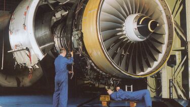 Engineers working on a large turbine at the Rolls-Royce Control and Monitoring Systems University Technology Centre.