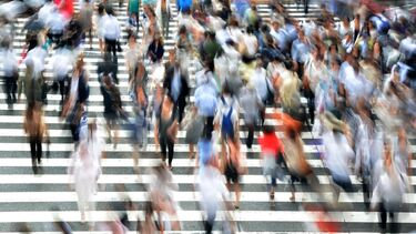 Busy street with pedestrians crossing the road.