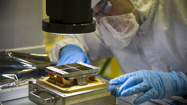 Scientist looking under microscope