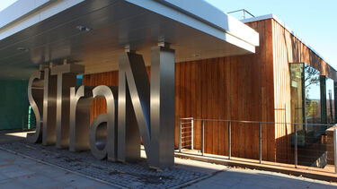 The SITraN facility from outside. It's a sunny day. The large SITraN letters can be seen very clearly.