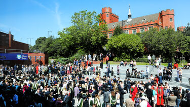 Sunny campus full of people