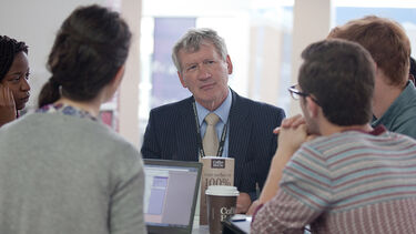 A group of students sat with a study abroad adviser