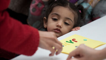 Photograph of girl observing an activitiy