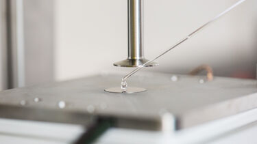 A researcher loads a sample into a rheometer