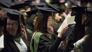 G student looking at certificate