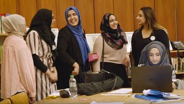 Women stood in Glasgow Women's Library talking together