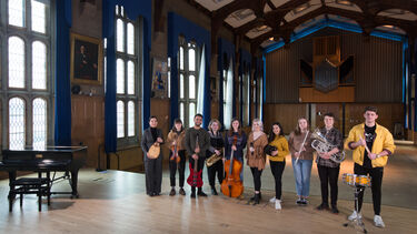 students on stage holding instruments 