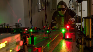 A researcher using an optical microscope