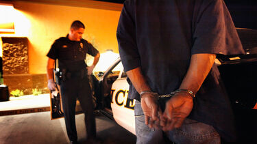 A prisoner in handcuffs.