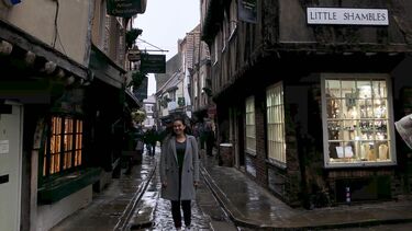 Smiling female student in Little Shambles cobbled street