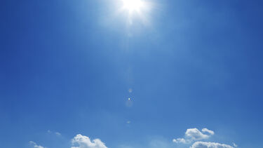 Blue Sky and Clouds with Sunburst