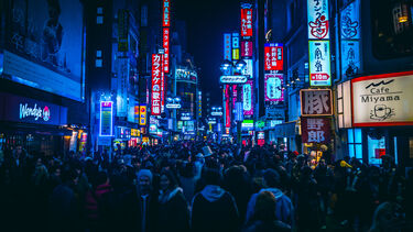 A crowded street in Tokyo at night