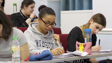 Undergraduate students making notes in a lecture. 
