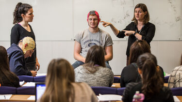Professor Elizabeth Milne demonstrates electroencephalography in an undergraduate psychology class.