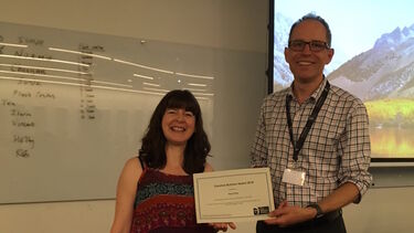 A member of the Bateson Centre being presented with the Caroline Butcher Award by the Bateson Centre Director