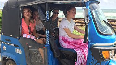 students sat smiling in a buggy whilst on placement abroad in Sri Lanka