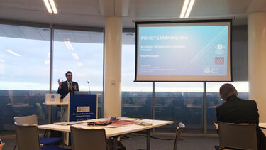 Speaker presenting at a conference.