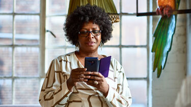 An adult woman using a smartphone.