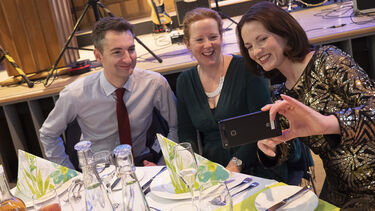 Alumni at a reunion event sat round the table