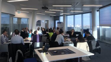 A group of Policy Leanring Lab attendees listening to a presentation - image