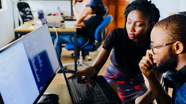 Woman and man working together at a computer