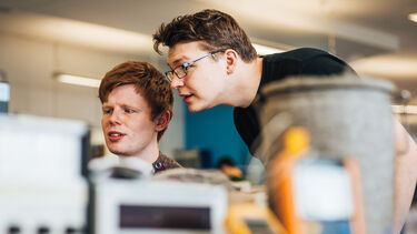 Students look at a screen in the lab