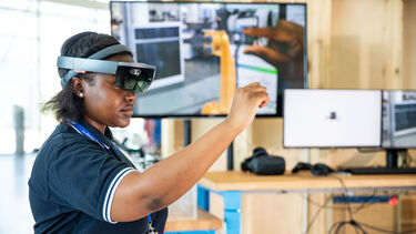 A member of staff uses goggles to complete some work - image