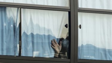 A person looking through a window