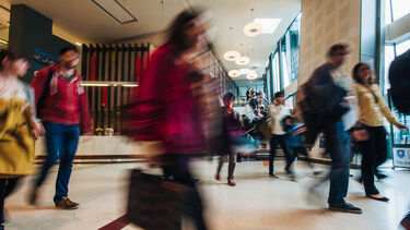 A group of people walking through a hallway