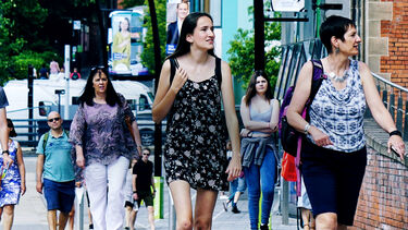Students and parents walking through campus on a University open day. 