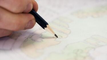 Hand sketching a plan in the studio