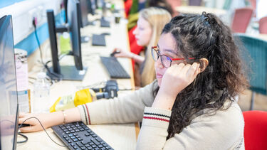 Student using computer in shared study space