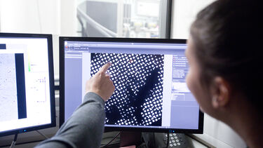 Researchers looking at image results on screen