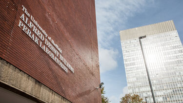 An exterior photo of the Alfred Denny Museum with the Arts Tower in the background