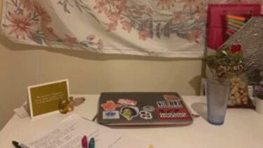 Home desk set up with laptop, pen and paper