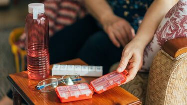 Senior Woman Holding Daily Pill Container