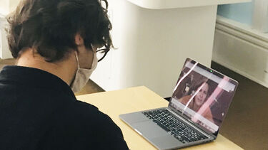 Final year student of Dutch asks questions via a laptop on which guest authors Niña Weijers is visible