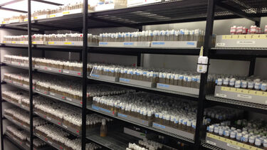 Racks containing hundreds of different Drosophila stock lines in vials.