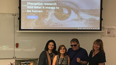 A group of people stood in front of a presentation
