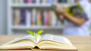 Plant flourishing from a book