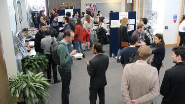 Workshop participants stand and discuss Multiscale Modelling