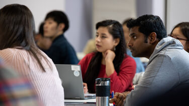 Group of students listen to lecture