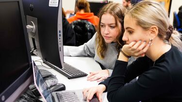 Two students looking at a computer screen
