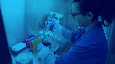 A neuroscience research student using a pipette