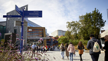 People walking on the concourse in the heart of the University of Sheffield's campus, near its Students' Union building