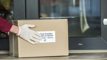 A box of personal protective equipment being delivered.