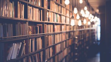 Blurred view of a corridor of books on shelves