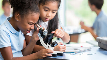 Children using a microscope