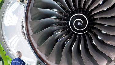 A Rolls Royce engineer inspects a turbine